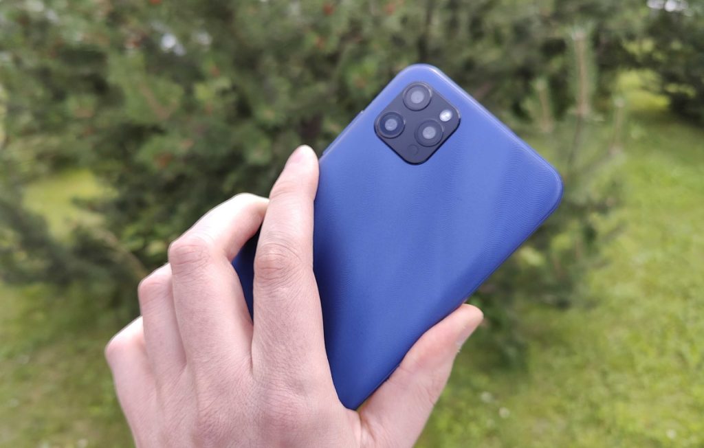 A blue smartphone held outdoors